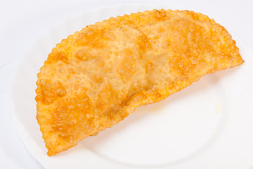 cheburek with lamb on white plate