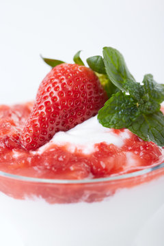 greek youghurt and strawberry in a glass cup