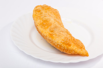 cheburek with lamb on white plate