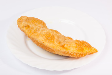 cheburek with lamb on white plate