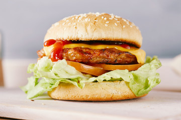 cheeseburger on a white chopping board