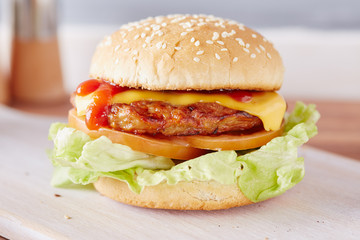 cheeseburger on a white chopping board