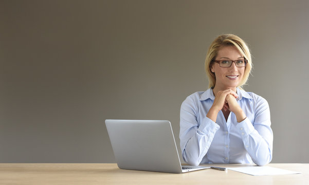 Portrait of businesswoman using laptop, isolated