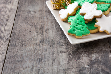 Christmas cookies on a plate and wooden table background

