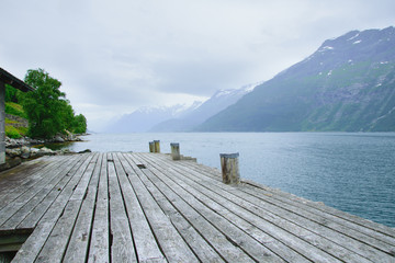 pier for boats on the shore of the fjord with the rocky shores