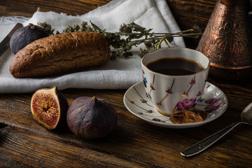 Light breakfast with coffee, bread and few figs.