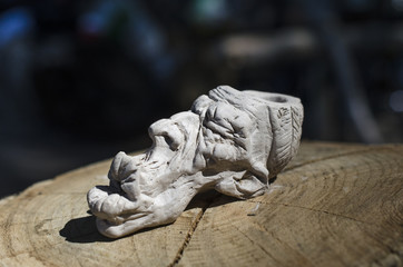 Obraz premium smoking pipe, Indian head, clay figurine