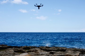 drone hovering over sea