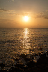 Fototapeta premium The sun rising over the sea