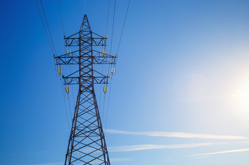 Electricity pylon against blue sky