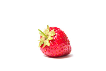 Red and ripe strawberry lies on its side on a white background