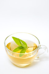 Glass transparent cup with tea and green mint leaf