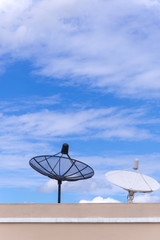 satellite dishes / antenna on the roof of the building with blue