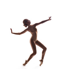 Ballerina in beige outfit posing on toes