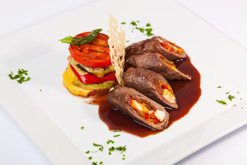 meat rolls with sauce and vegetables cheese