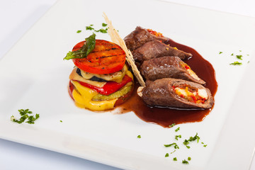 meat rolls with sauce and vegetables cheese