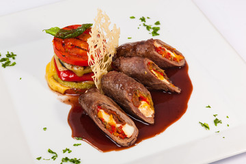 meat rolls with sauce and vegetables cheese
