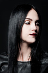 Fototapeta premium Gorgeous brunette with white skin, red lips on black backdrop