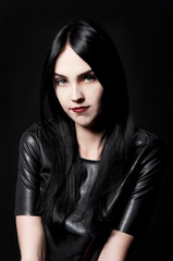 Fototapeta premium Gorgeous brunette with white skin, red lips on black backdrop