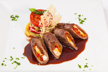 meat rolls with sauce and vegetables cheese