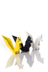 Origami art, colored squirrels isolated over a white background