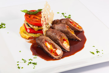 meat rolls with sauce and vegetables cheese