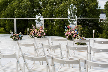 Original wedding altar made of ice sculptures stands in the fron