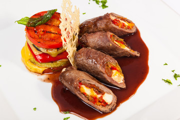 meat rolls with sauce and vegetables cheese