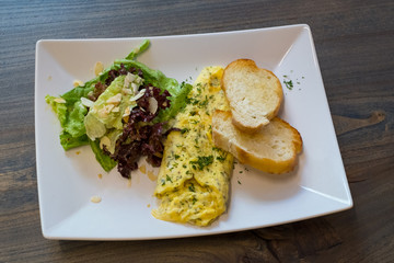 Scrambled eggs on the plate for breakfast in cafe
