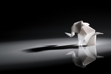 Cute origami art, colored shapes object isolated over a black background