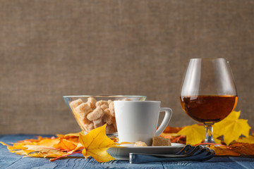 Loving cognac with autumn leaves