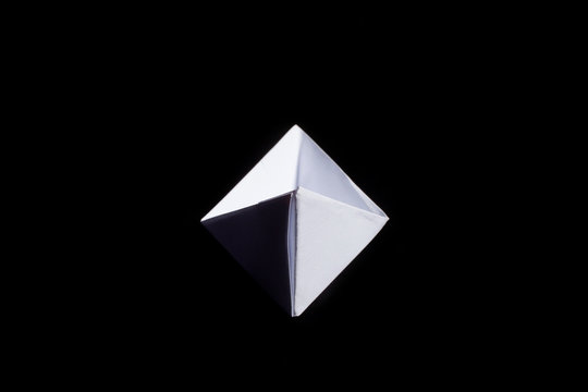 Cute origami art, colored shapes object isolated over a black background