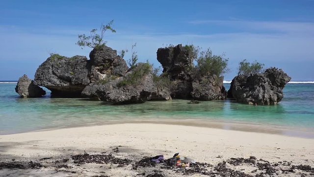 Large eroded limestone rocks in the lagoon close to sandy beach, Rurutu island, south Pacific ocean, Austral archipelago, French Polynesia
