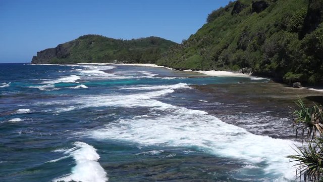 Coastal landscape of Rurutu island, high view over waves breaking on the seashore, south Pacific ocean, Austral archipelago, French Polynesia
