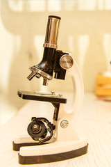 School small a microscope is on the table.