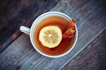 hot tea with lemon on wooden table.