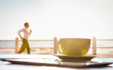 Composite image of sporty woman jogging at promenade
