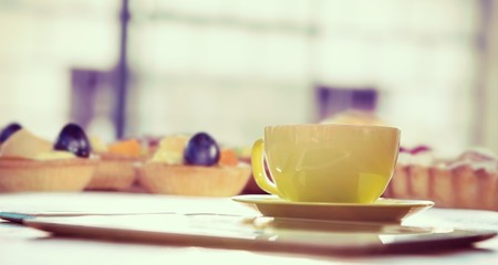 Composite image of cup of coffee and tablet pc