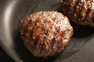 beef cutlets rest on frying pan