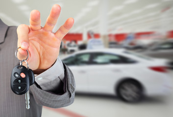 Dealer hand with a car key.