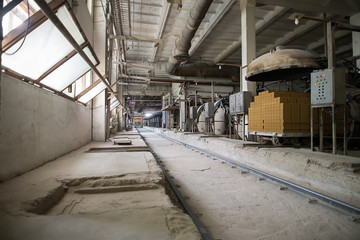 Fototapeta na wymiar Industry. Photo of old dusty workshop at brickyard
