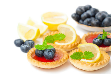 set  of tasty tartlets with lemon and raspberry jam isolated