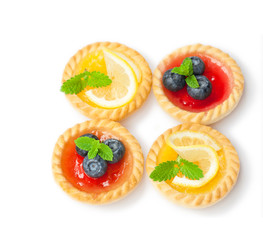 set  of tasty tartlets with lemon and raspberry jam isolated