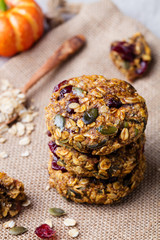 Oat cookies with cranberries and maple glaze on rustic textile background.