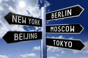 Obraz premium Signpost with 5 arrows - capital cities (Berlin, New York, Moscow, Beijing, Tokyo) - great for topics like traveling, international business/ trade, globalization etc.