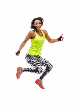 A woman in green sportswear jumping.