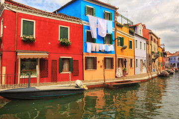 Fototapeta na wymiar Exterior of colorful houses of Burano Island in Venice.Windows,walls,laundries,flowers and even umbrellas reflects the culture of the people in the island.