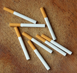 cigarettes scattered on old rusty wooden table