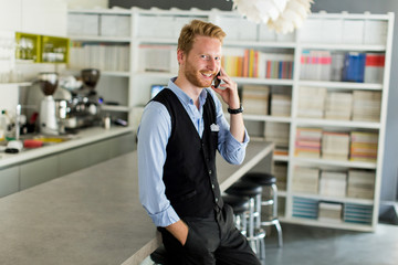 Young man with mobile phone in the office