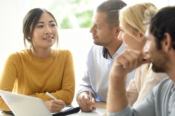 Business workgroup interacting in office